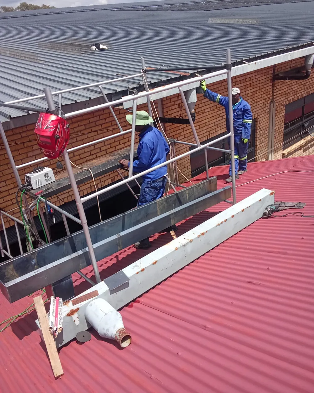 Client-supplied photograph of roof-edge work in progress